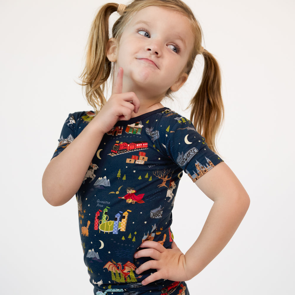 Close up image of a child posing wearing An Evening at Hogwarts two piece short sleeve pj set