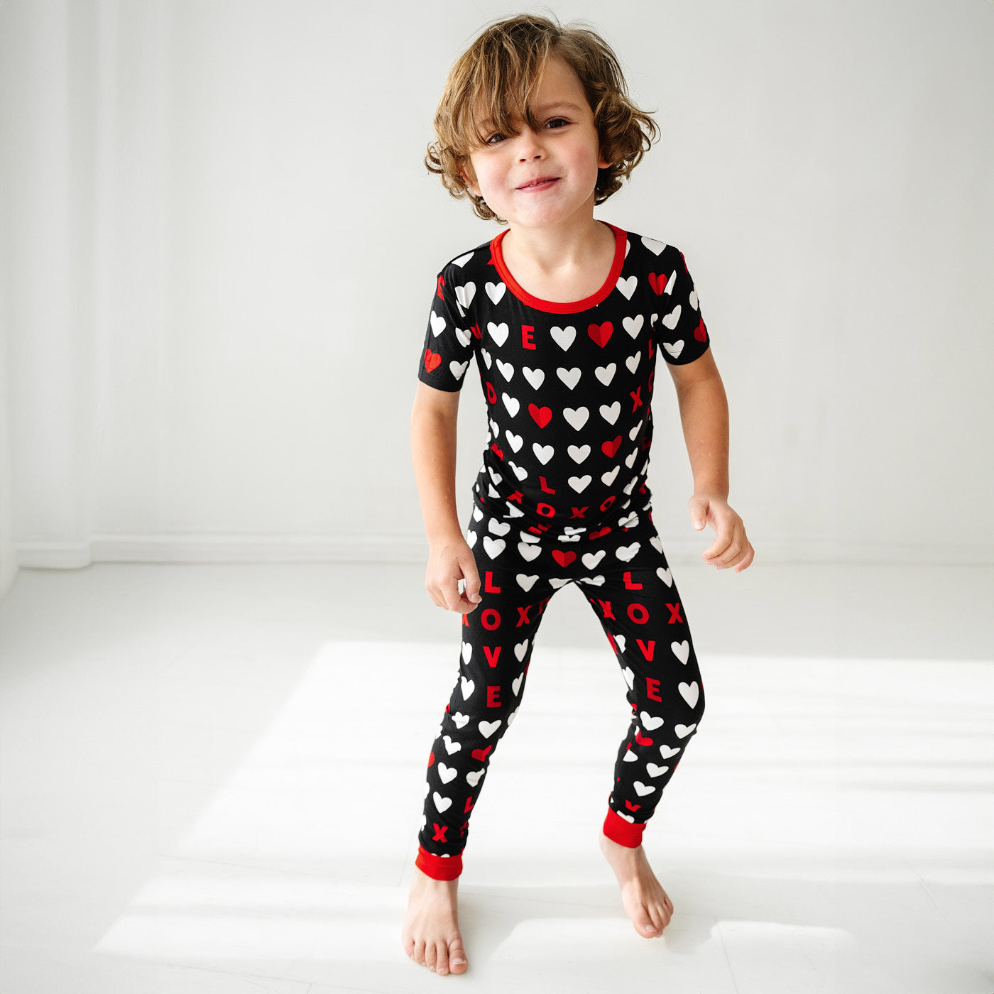 Child wearing Black XOXO two piece short sleeve pajama set