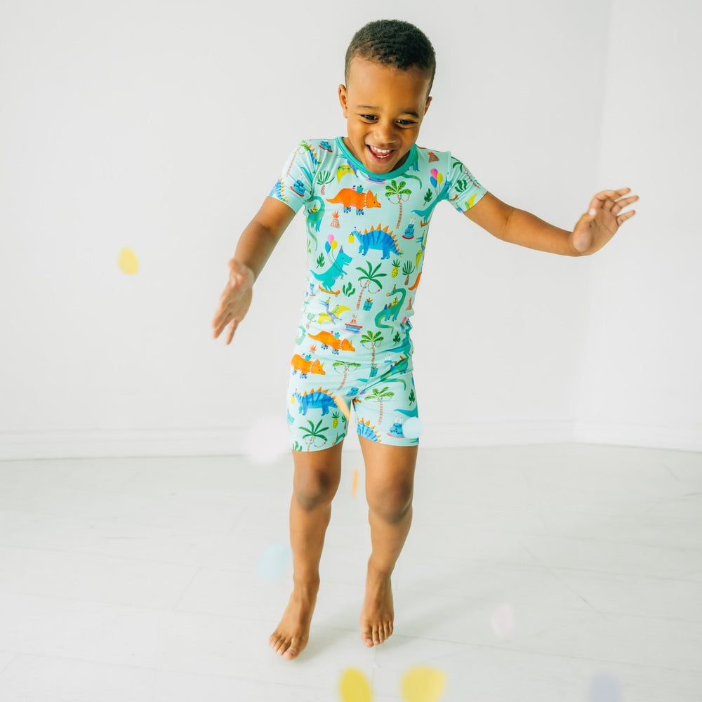 child playing wearing Prehistoric Party two piece short sleeve and shorts pj set