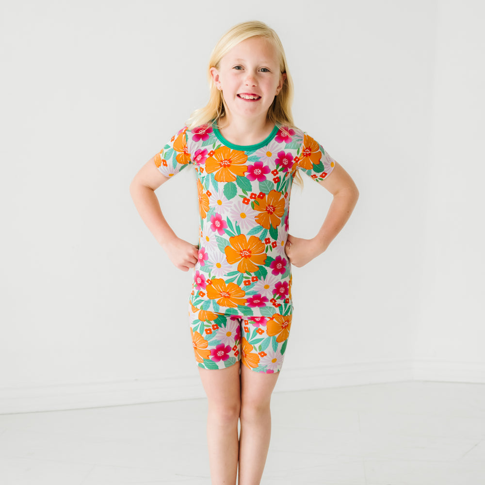 child posing wearing Beachy Blooms two piece short sleeve and shorts pajama set