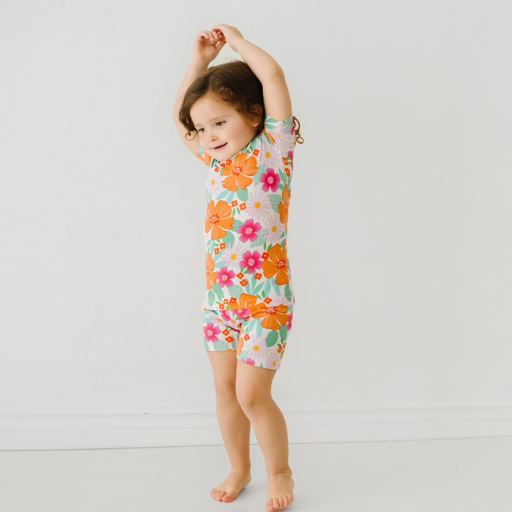 Alternate image of a child posing wearing Beachy Blooms two piece short sleeve and shorts pajama set