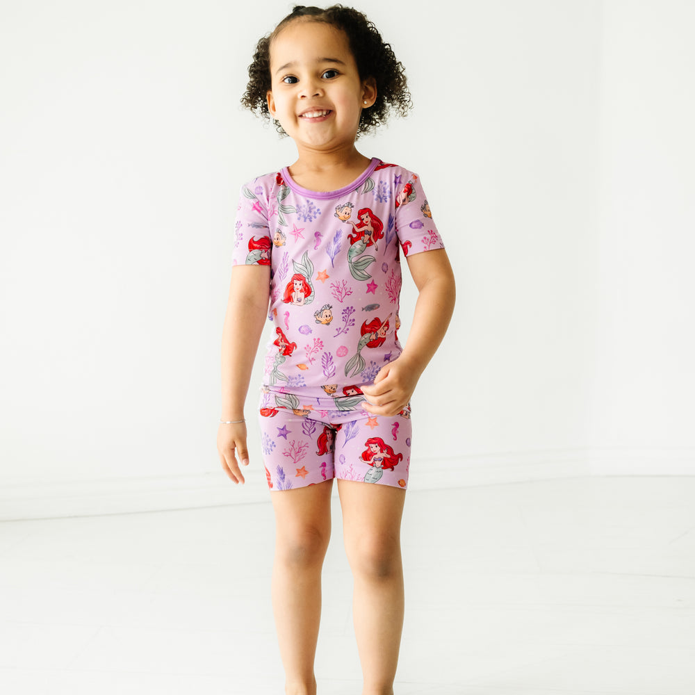 Child wearing Disney Part of Her World two piece short sleeve and shorts pajama set