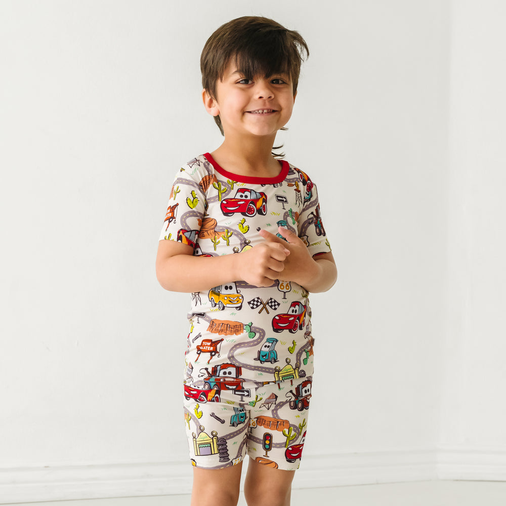 Close up image of a child wearing a Radiator Springs two piece short sleeve and shorts pajama set