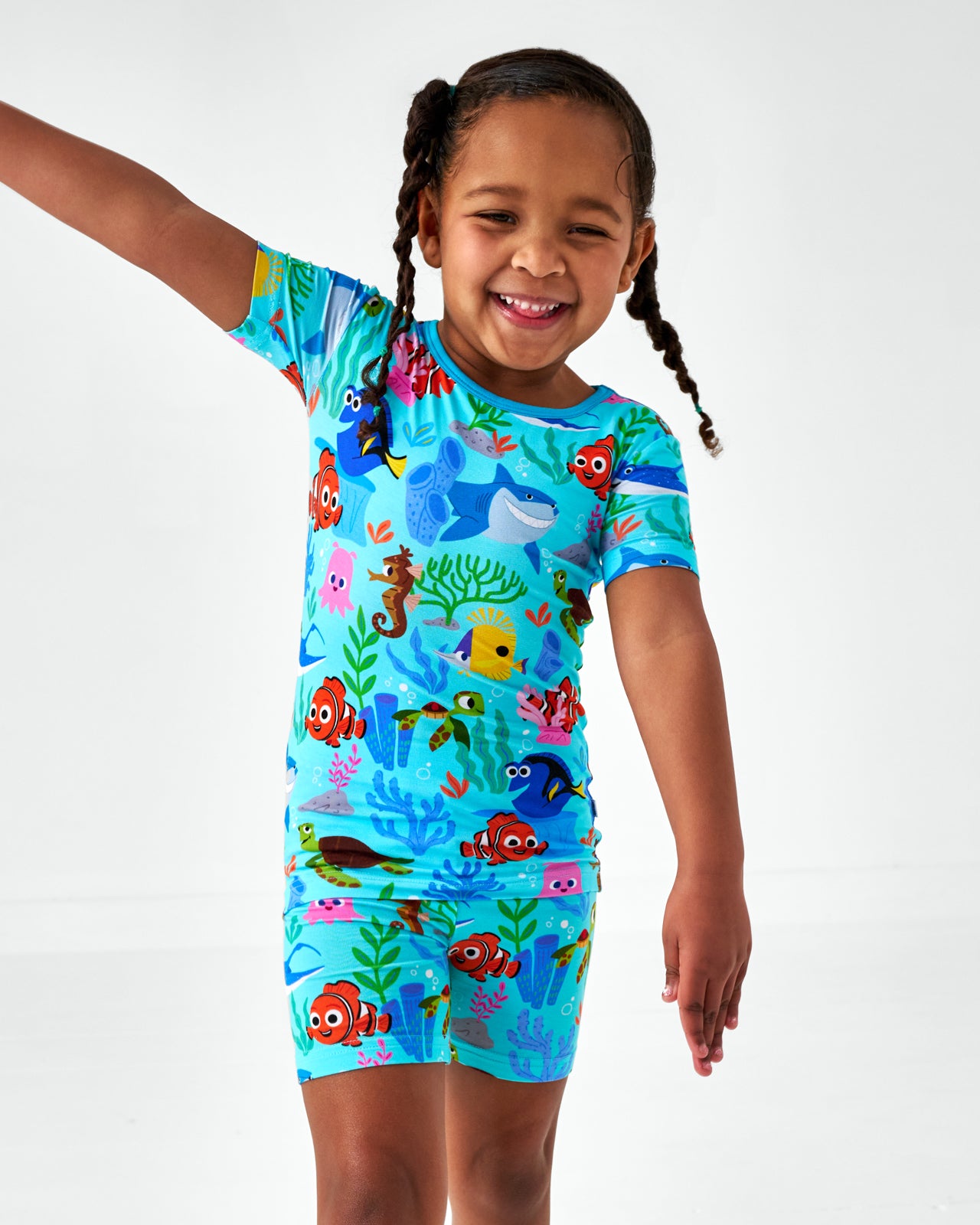 Close up of girl wearing the Pixar Nemo's Reef Two-Piece Short Sleeve & Shorts Pajama Set