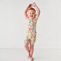 Child twirling wearing a Pink Ready to Rodeo two piece short sleeve and shorts pajama set