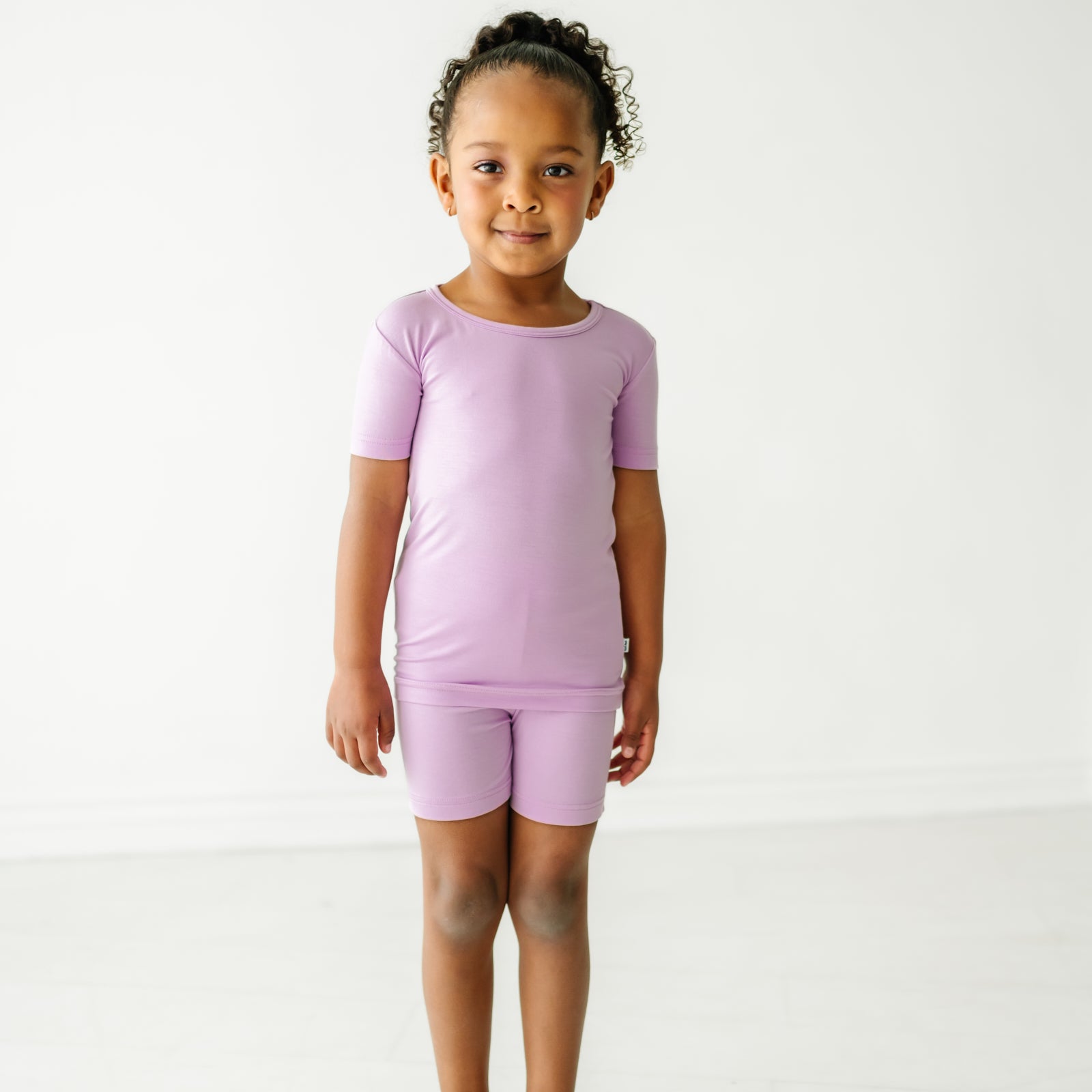 Child wearing a Light Orchid two piece shorts and short sleeve pajama set