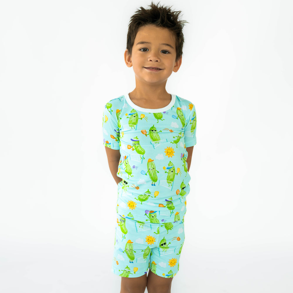 Boy standing while wearing the Pickle Power Two-Piece Short Sleeve & Shorts Pajama Set