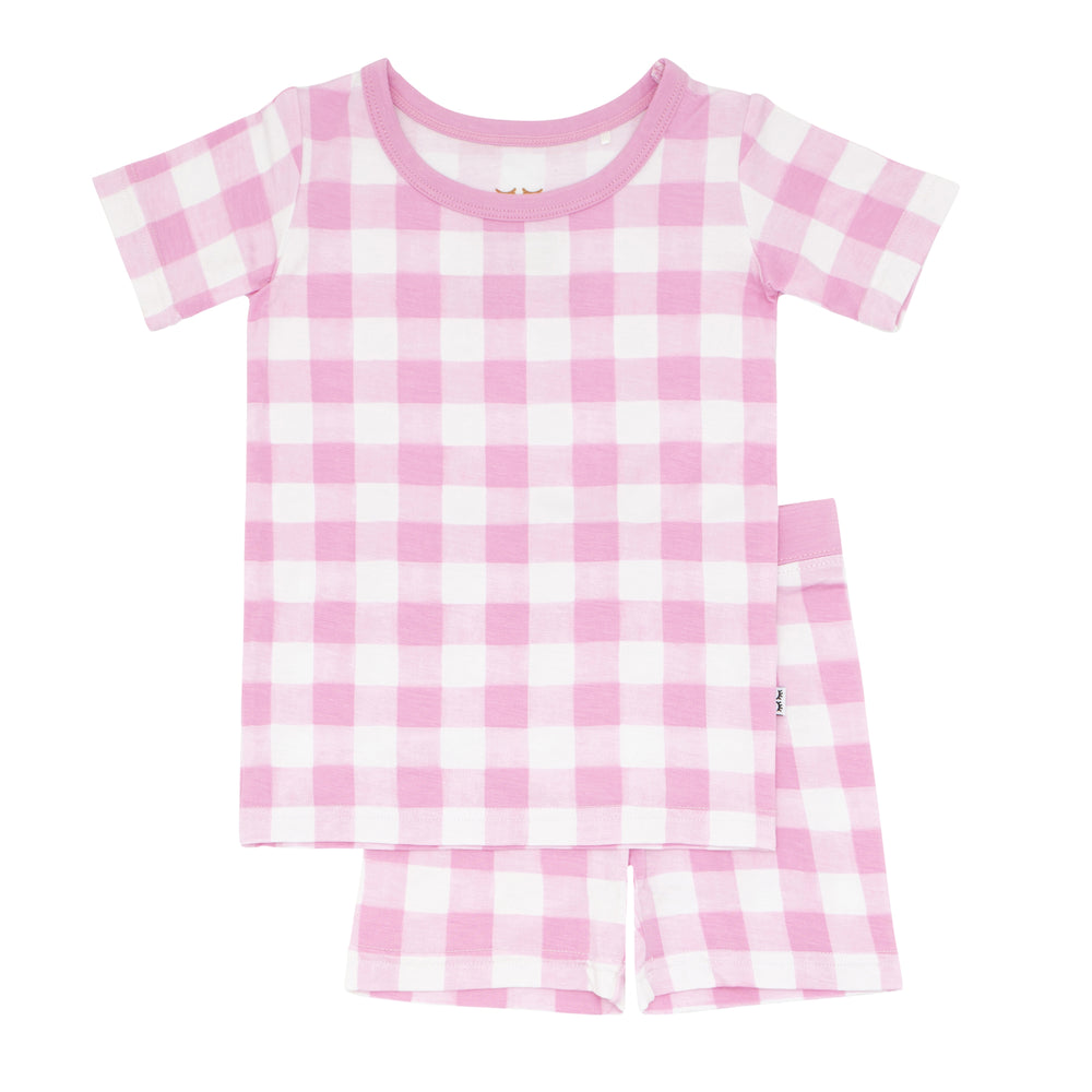 Flat lay image of a Pink Gingham two piece short sleeve and shorts pajama set