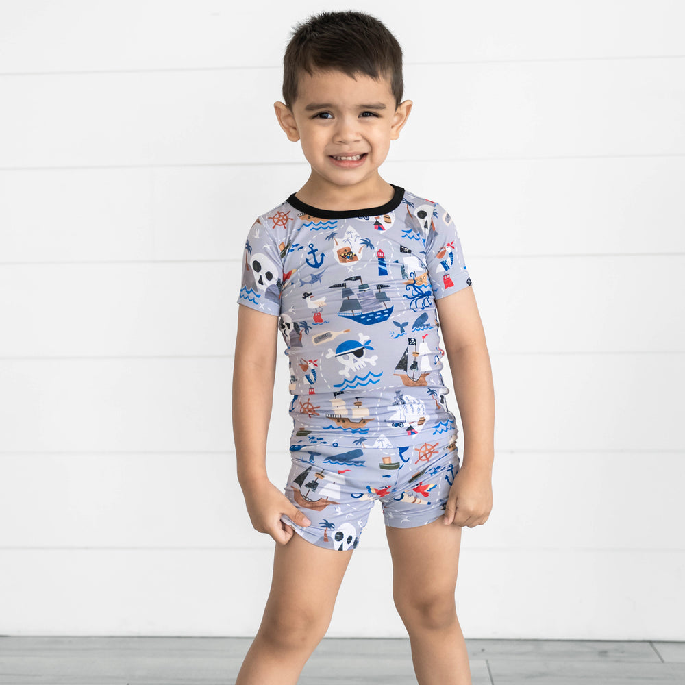 Boy wearing the Pirate's Map Two-Piece Short Sleeve & Shorts Pajama Set