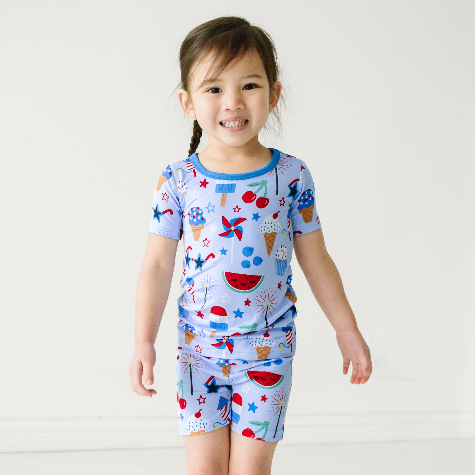 Child wearing Stars Stripes and Sweets two piece short sleeve and shorts pj set