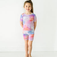 Child wearing a Pastel Tie Dye Dreams two-piece short sleeve & shorts pajama set