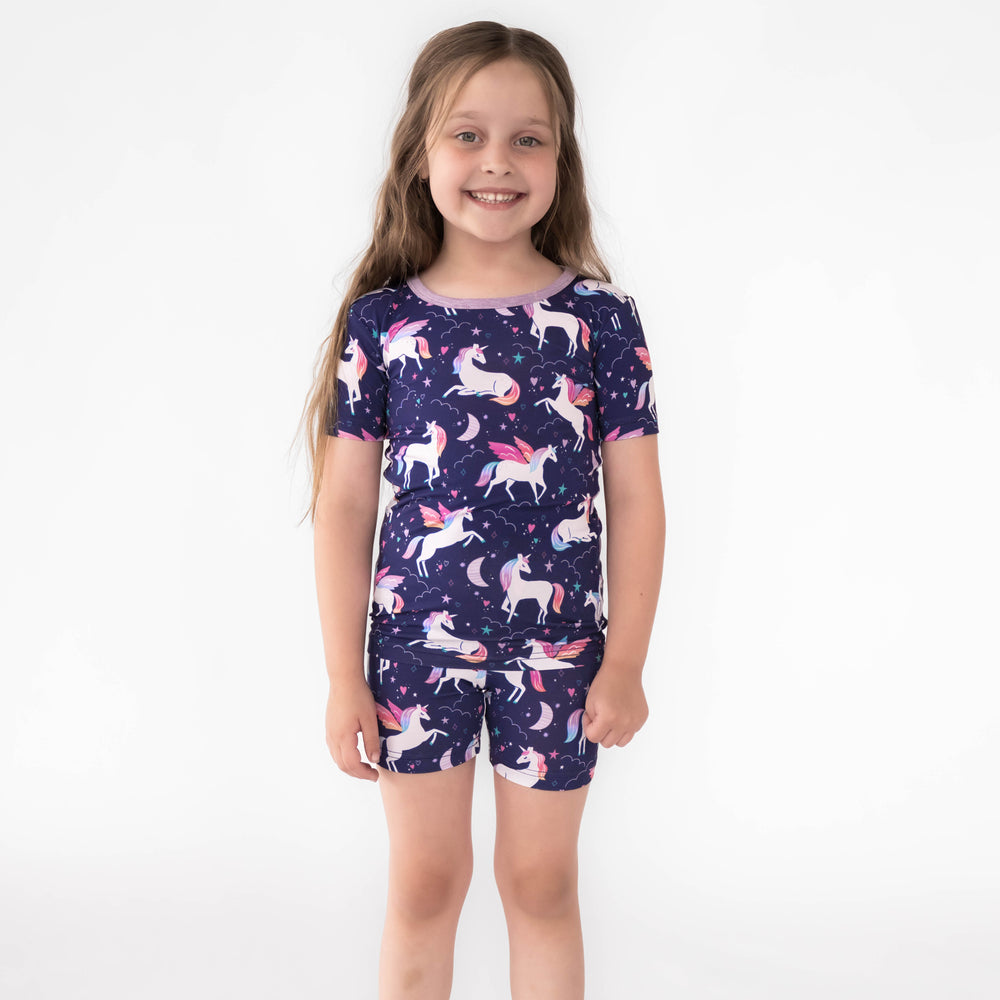 Girl wearing the Magical Skies Two-Piece Short Sleeve & Shorts Pajama Set