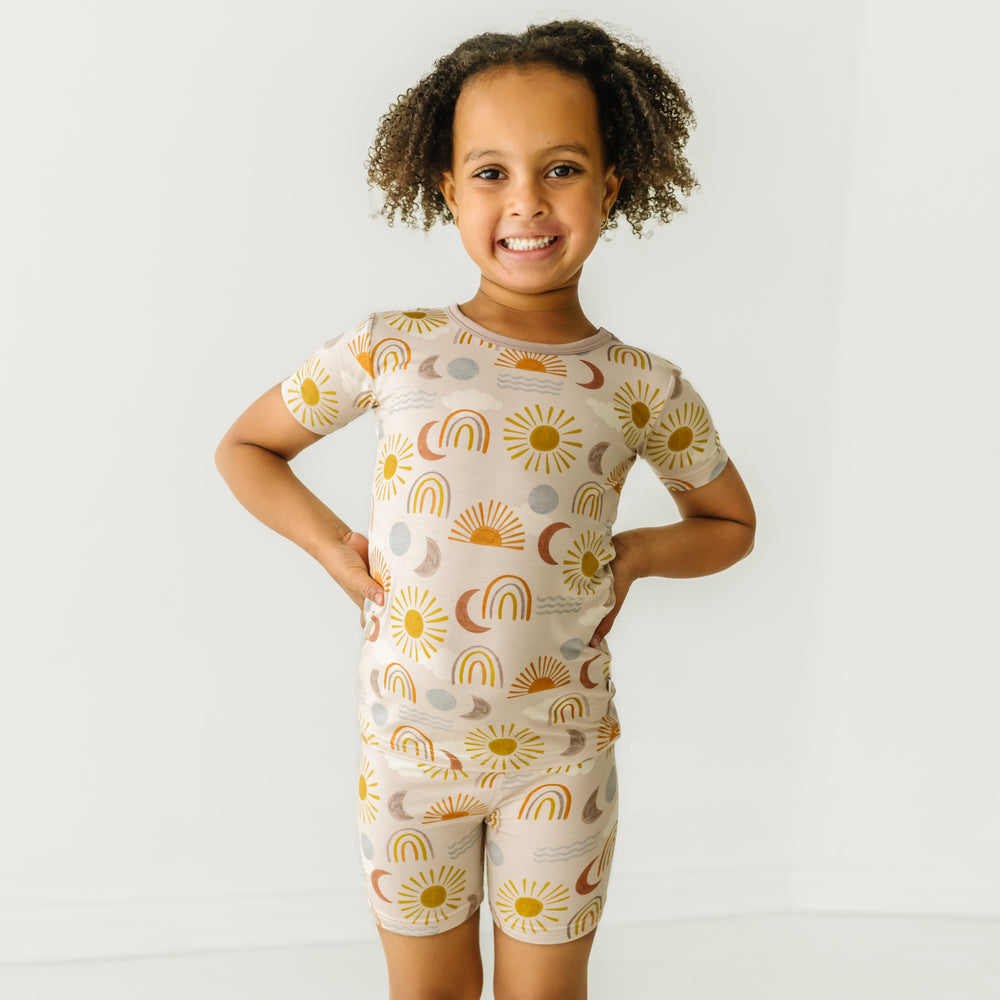 Child posing wearing a Desert Sunrise two piece short sleeve and shorts pajama set