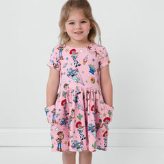 Child with her hands in the pockets of a Disney & Pixar Toy Story Stars Patch Pocket Dress