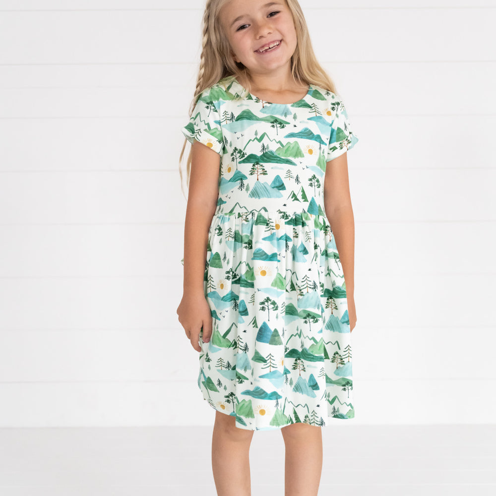 Image of a child wearing a Mountain Mist Patch Pocket Dress