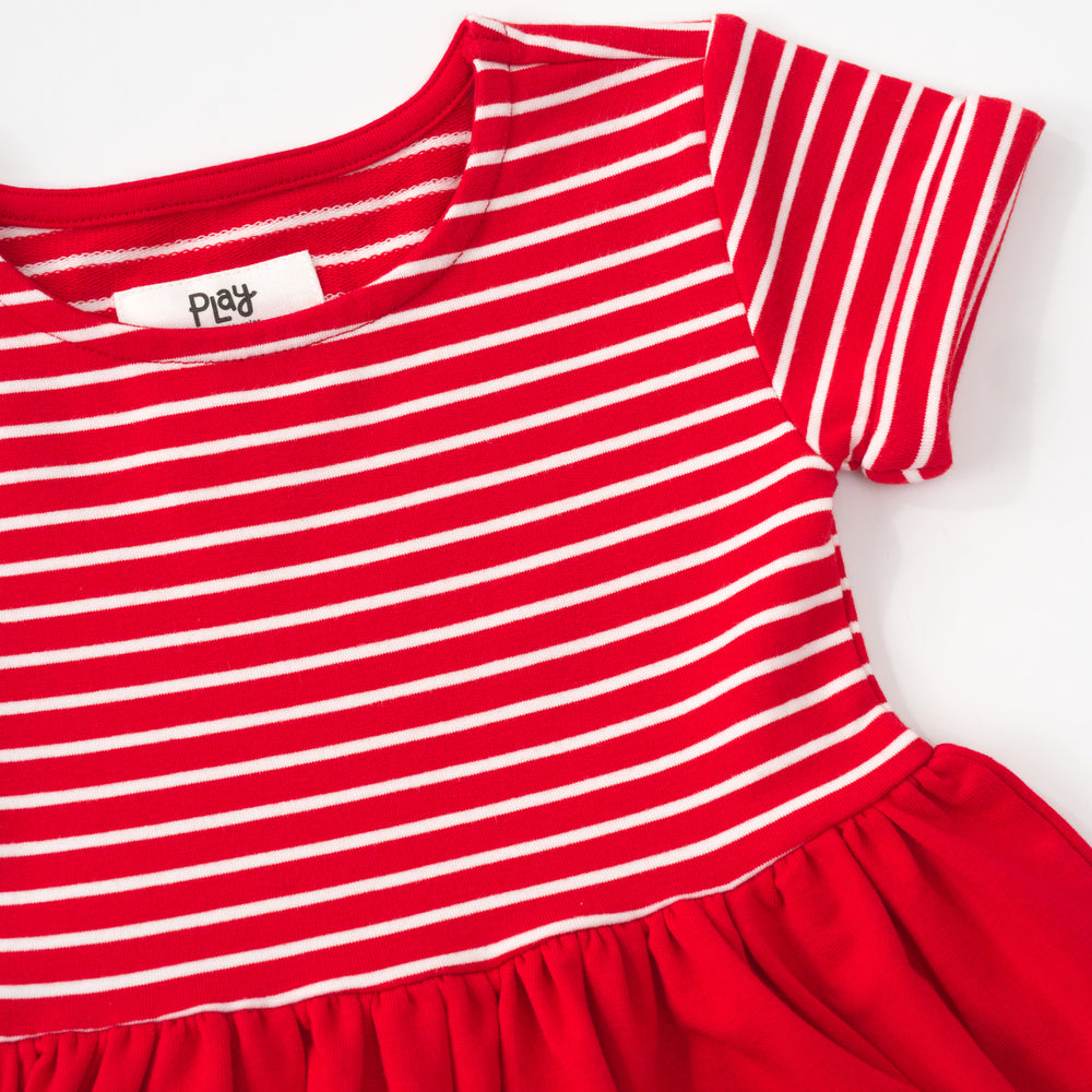 Close up flat lay of a candy red patch pocket dress