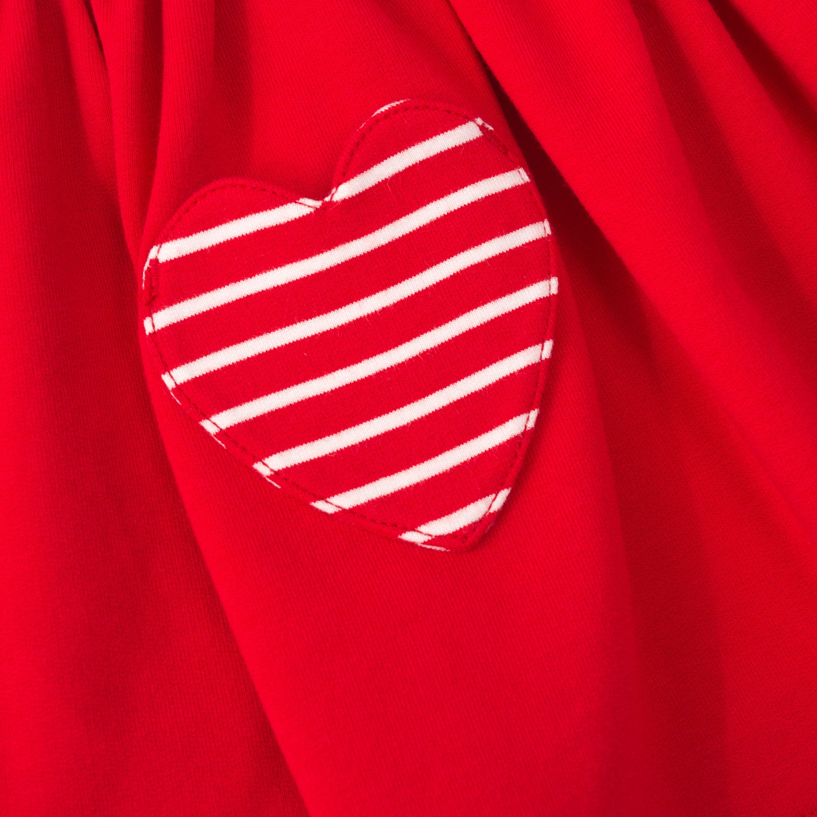 Close up view of the pocket on a candy red patch pocket dress