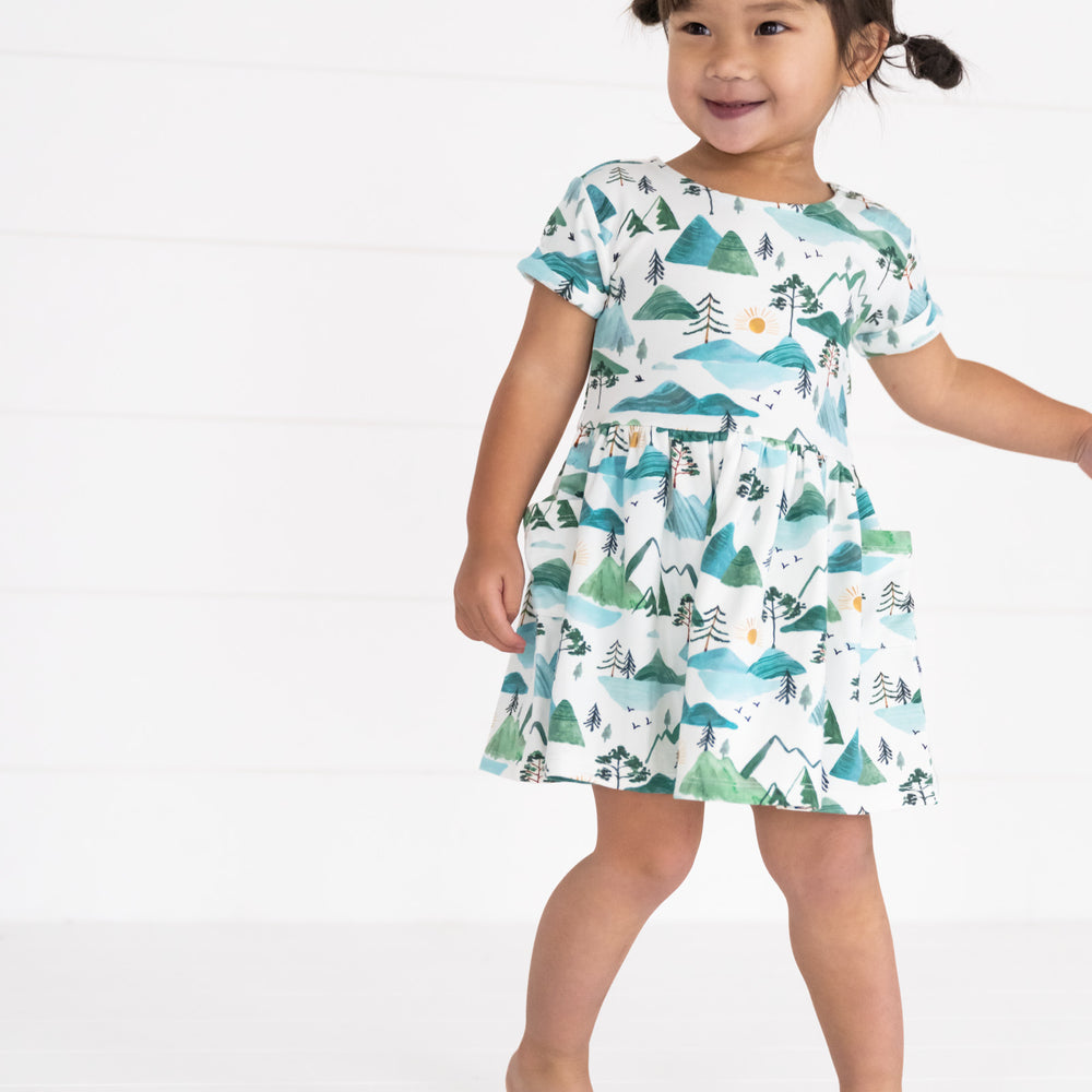 Image of a child wearing a Mountain Mist Patch Pocket Dress with Bloomer