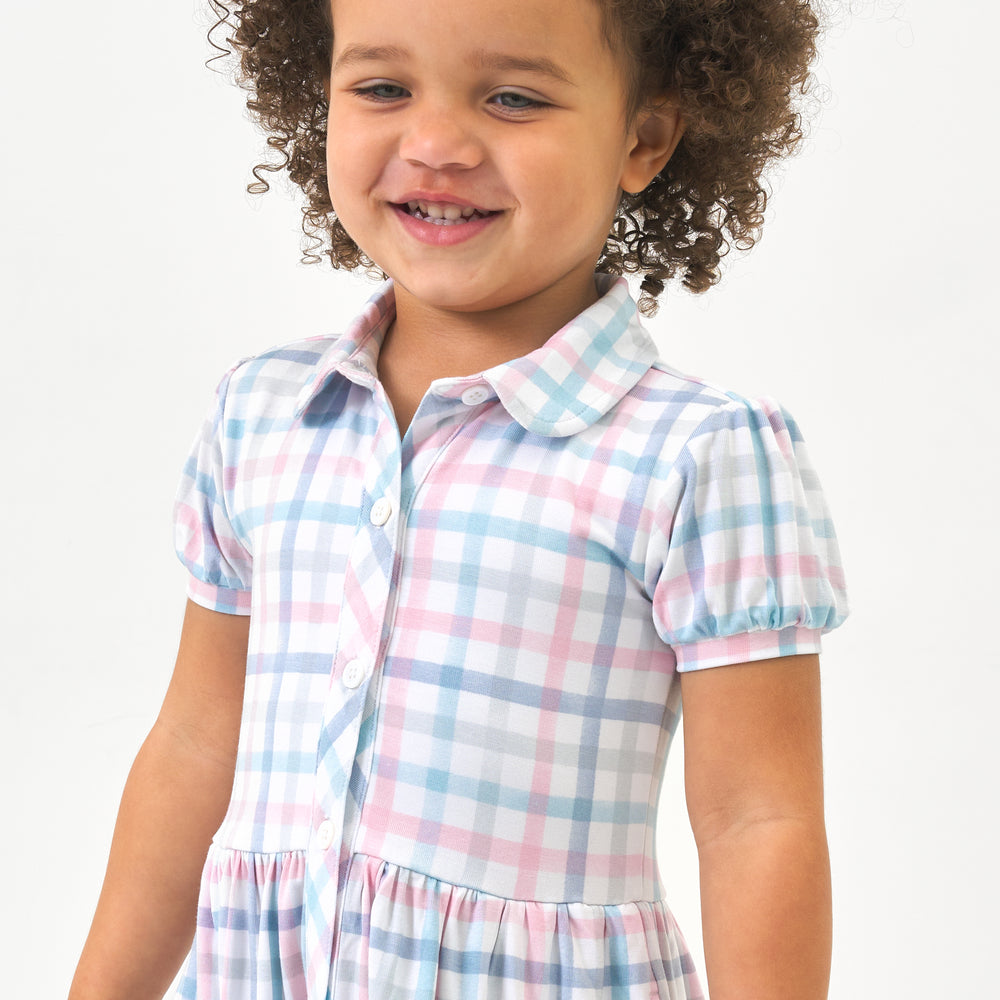 Click to see full screen - Alternate close up image of a child wearing a Playful Plaid puff sleeve button down dress