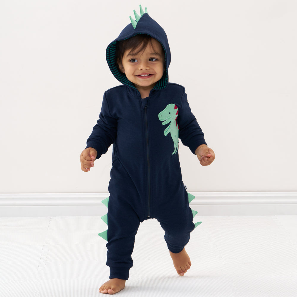 Click to see full screen - Child wearing a Dinosaur sweatsuit romper with the hood up