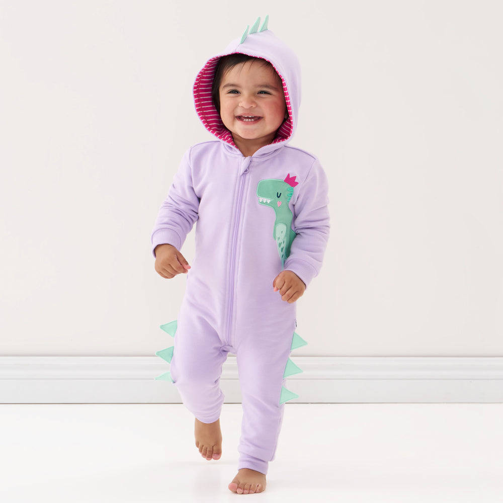 Click to see full screen - Child wearing a Loveasaurus sweatsuit romper with the hood up