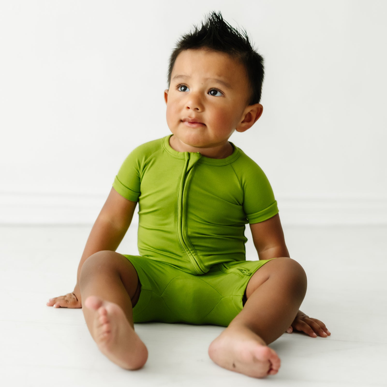 Child sitting wearing an Avocado Shorty Zippy