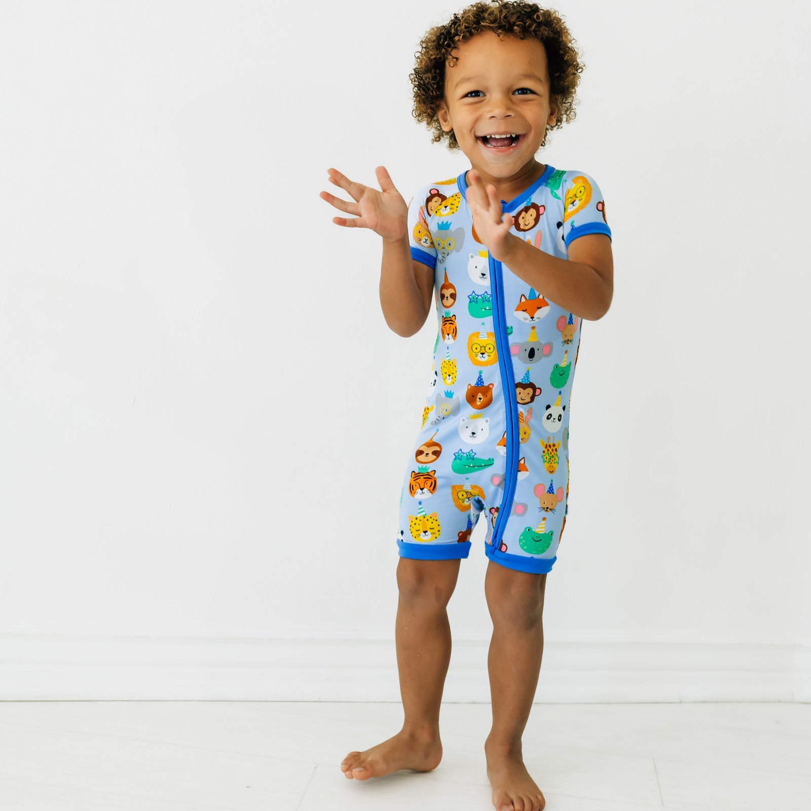 Child posing wearing a Blue Party Pals shorty zippy