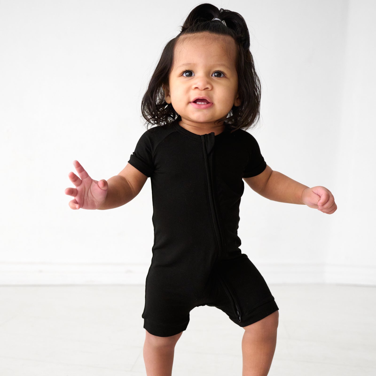 Child wearing a Black Solid shorty zippy