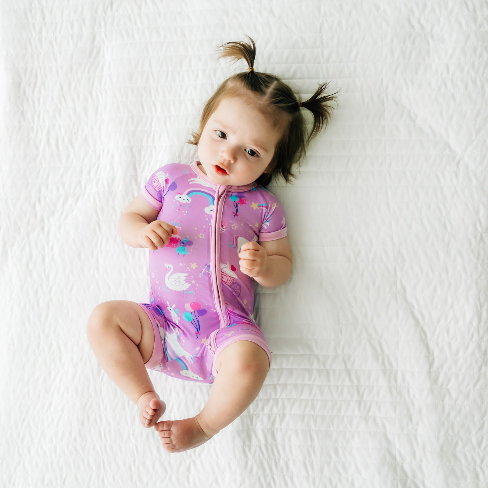 Child laying on a bed wearing Magical Birthday shorty zippy