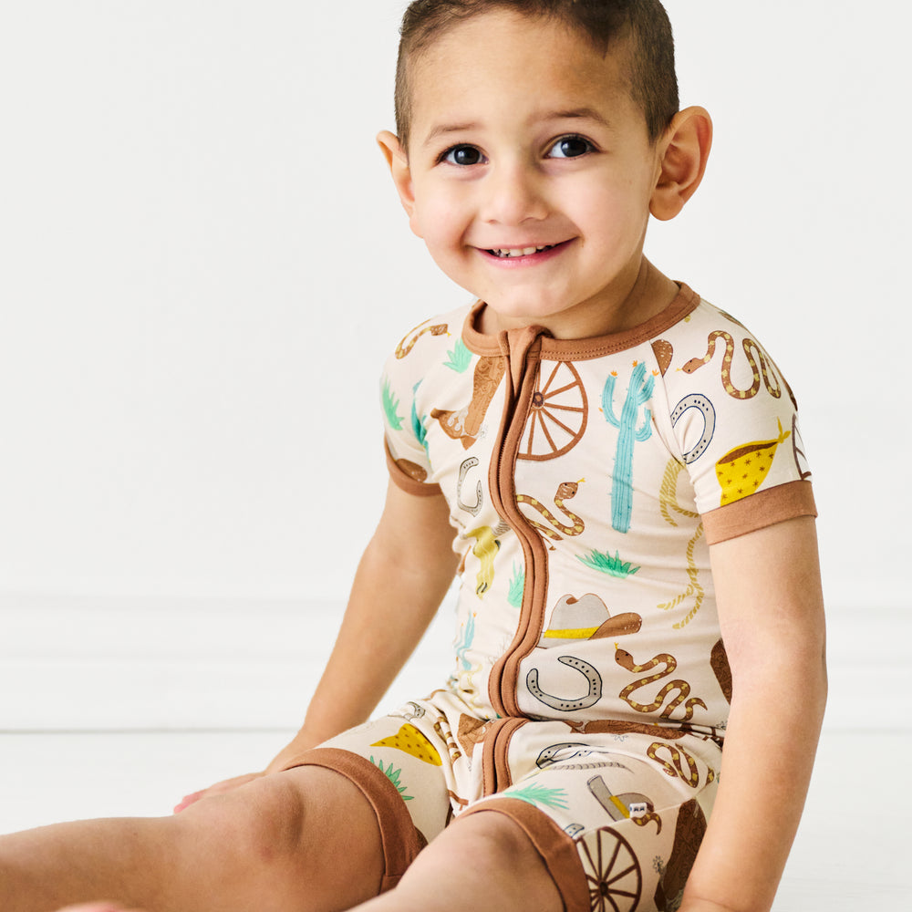 Alternate image of a child sitting wearing a Caramel Ready to Rodeo shorty zippy