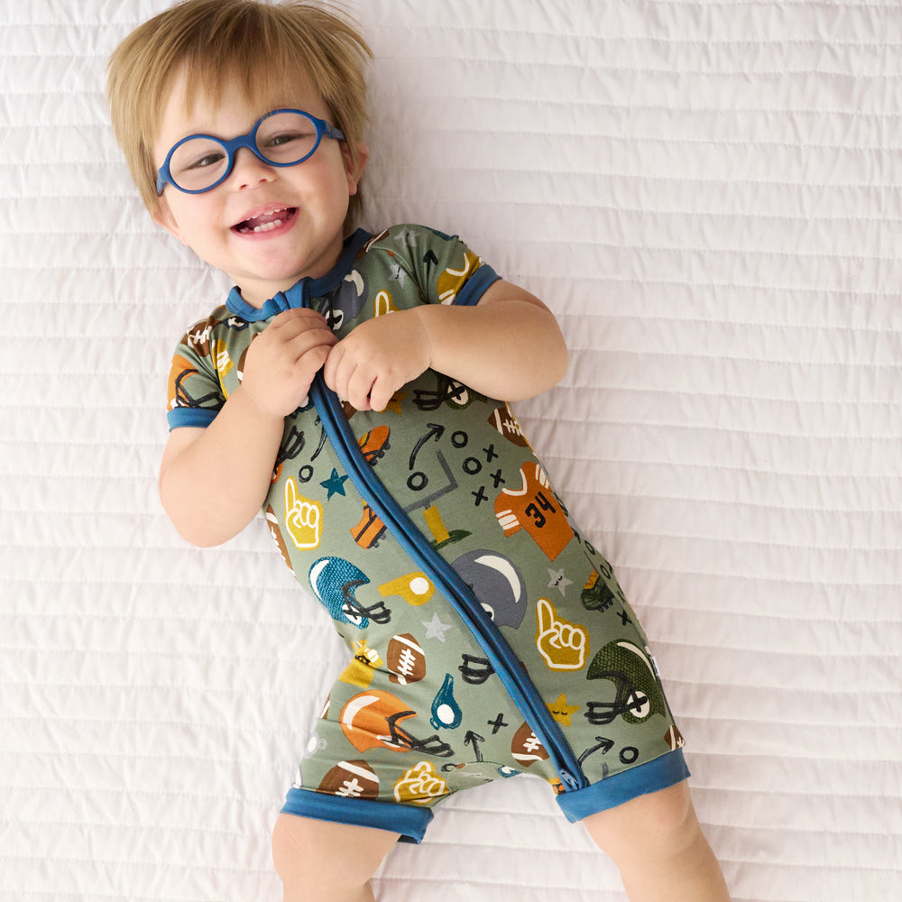 Top view image of child laying down while wearing the touchdown-time-shorty-zippy