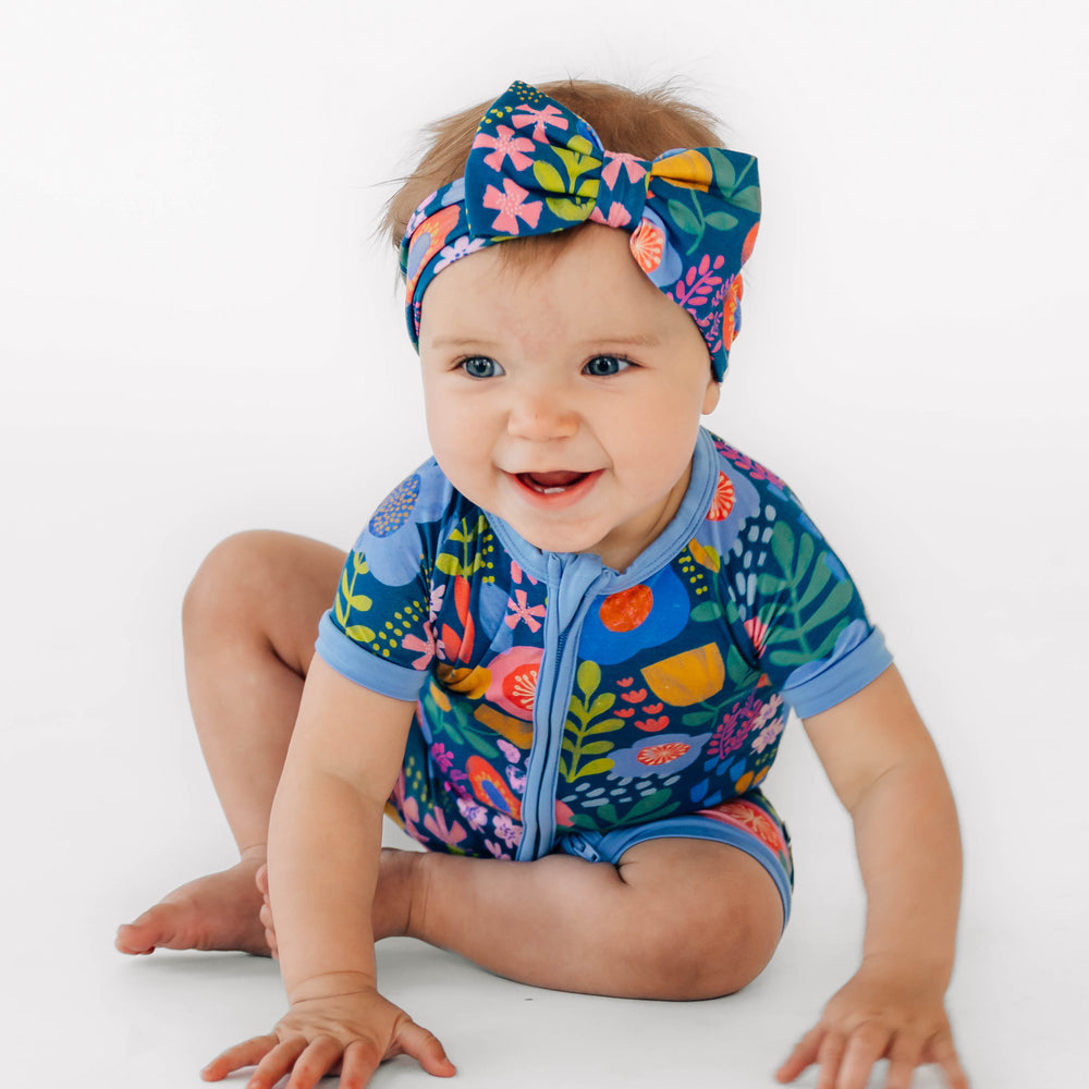 Alternative image of baby sitting while wearing the Folk Floral Luxe Bow Headband and Folk Floral Shorty Zippy