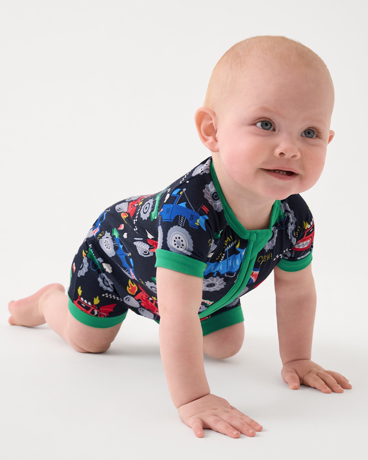 Crawling baby wearing the Monster Truck Madness Shorty Zippy