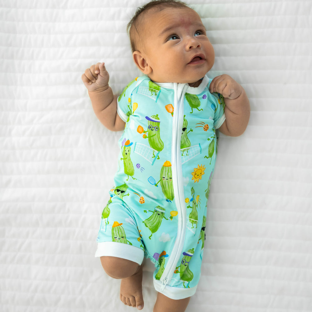 Infant laying down wearing the Pickle Power Shorty Zippy