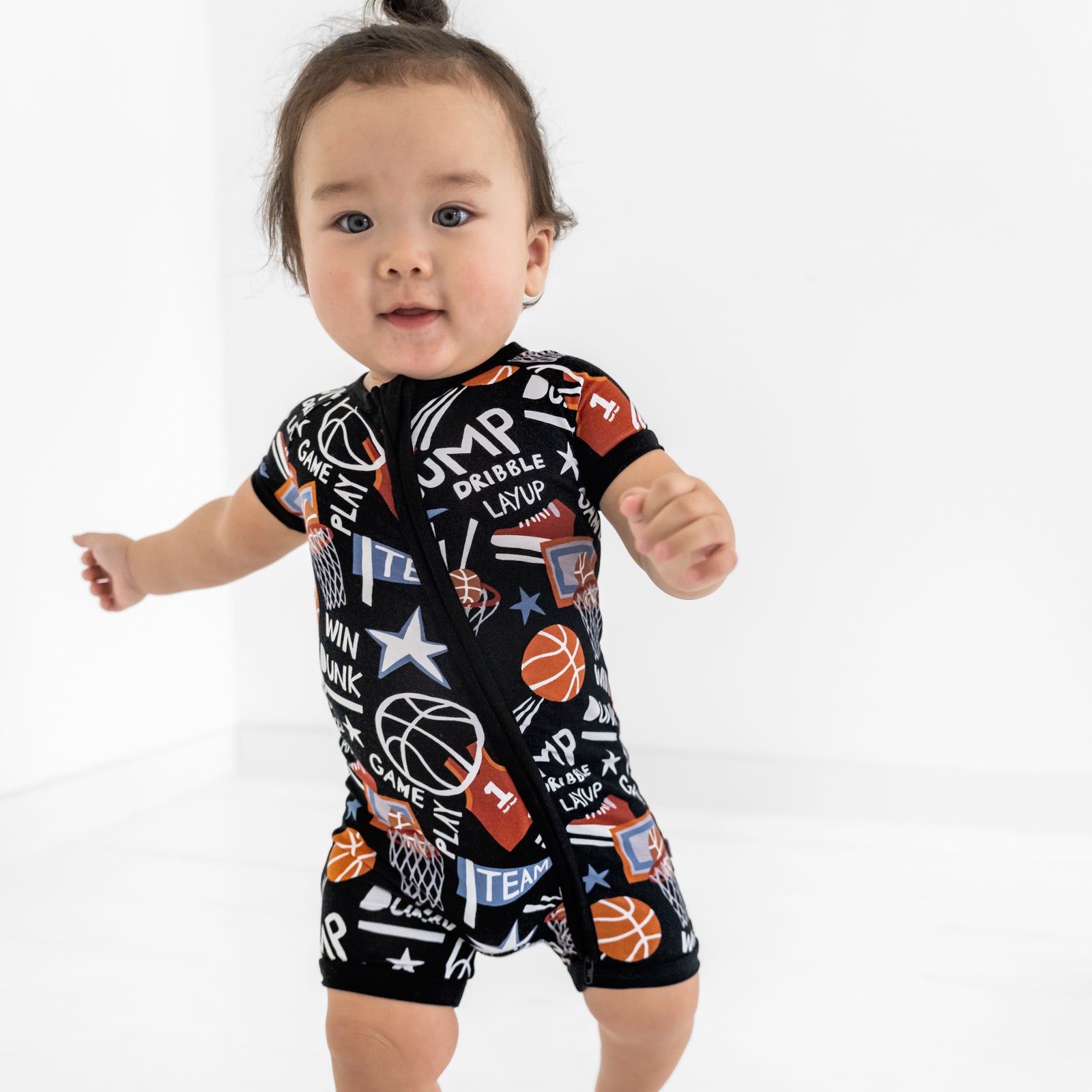 Close up of a child wearing the Black Slam Dunk shorty zippy