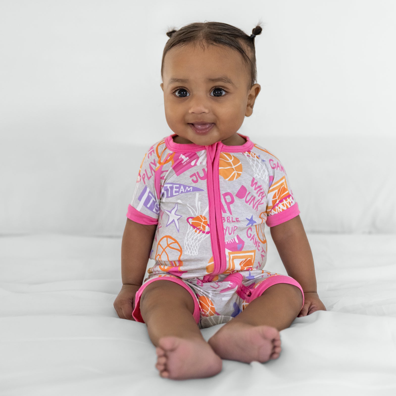 Child wearing the Pink Slam Dunk shorty bamboo zippy