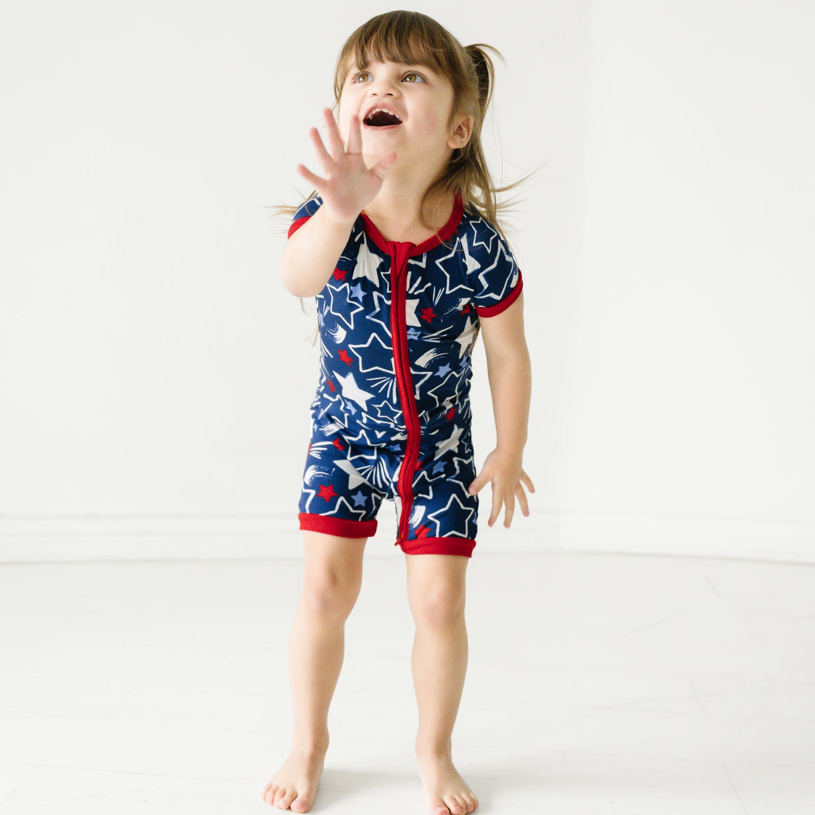 Child playing wearing a Star Spangled shorty zippy