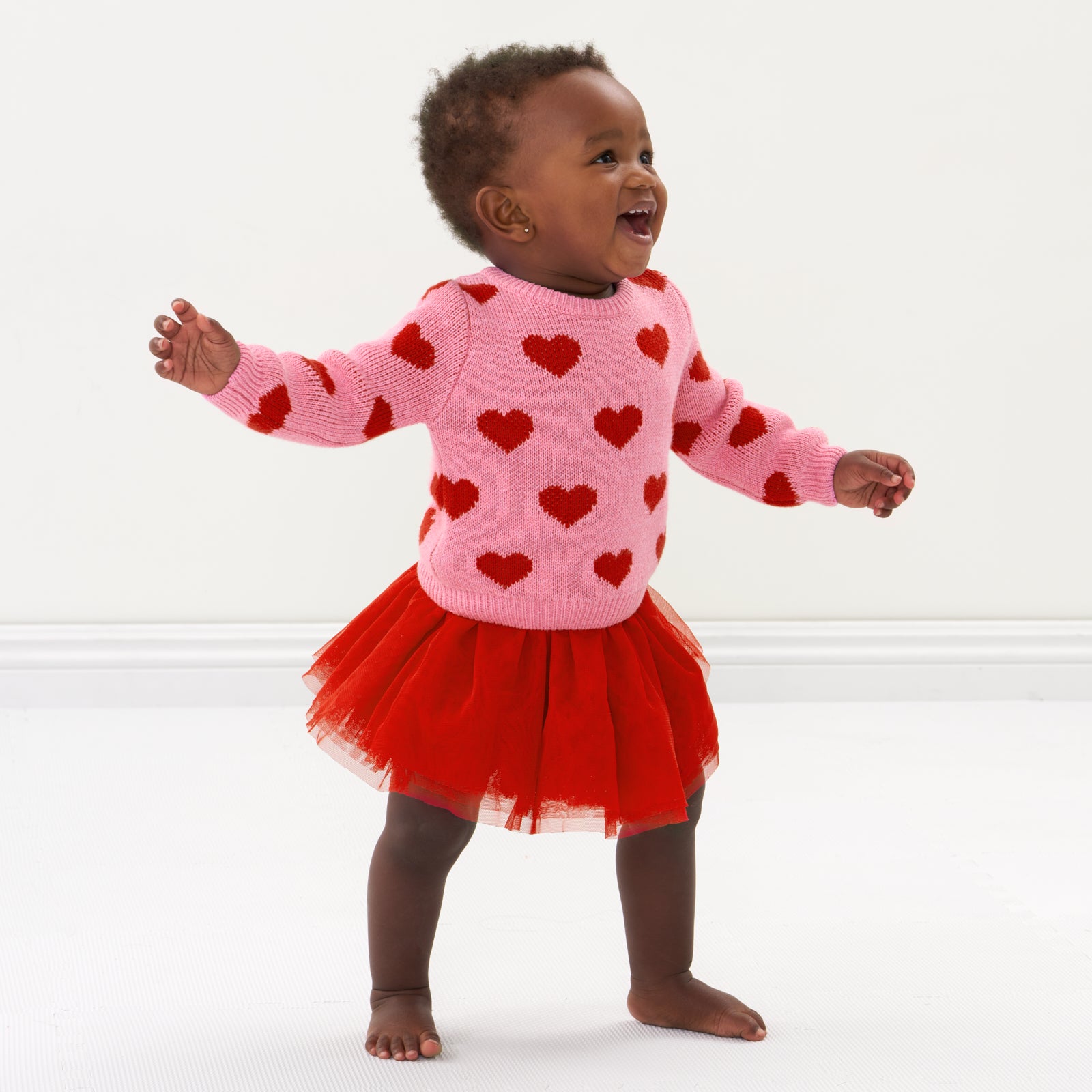 Child wearing a Hearts knit sweater and coordinating tutu skirt