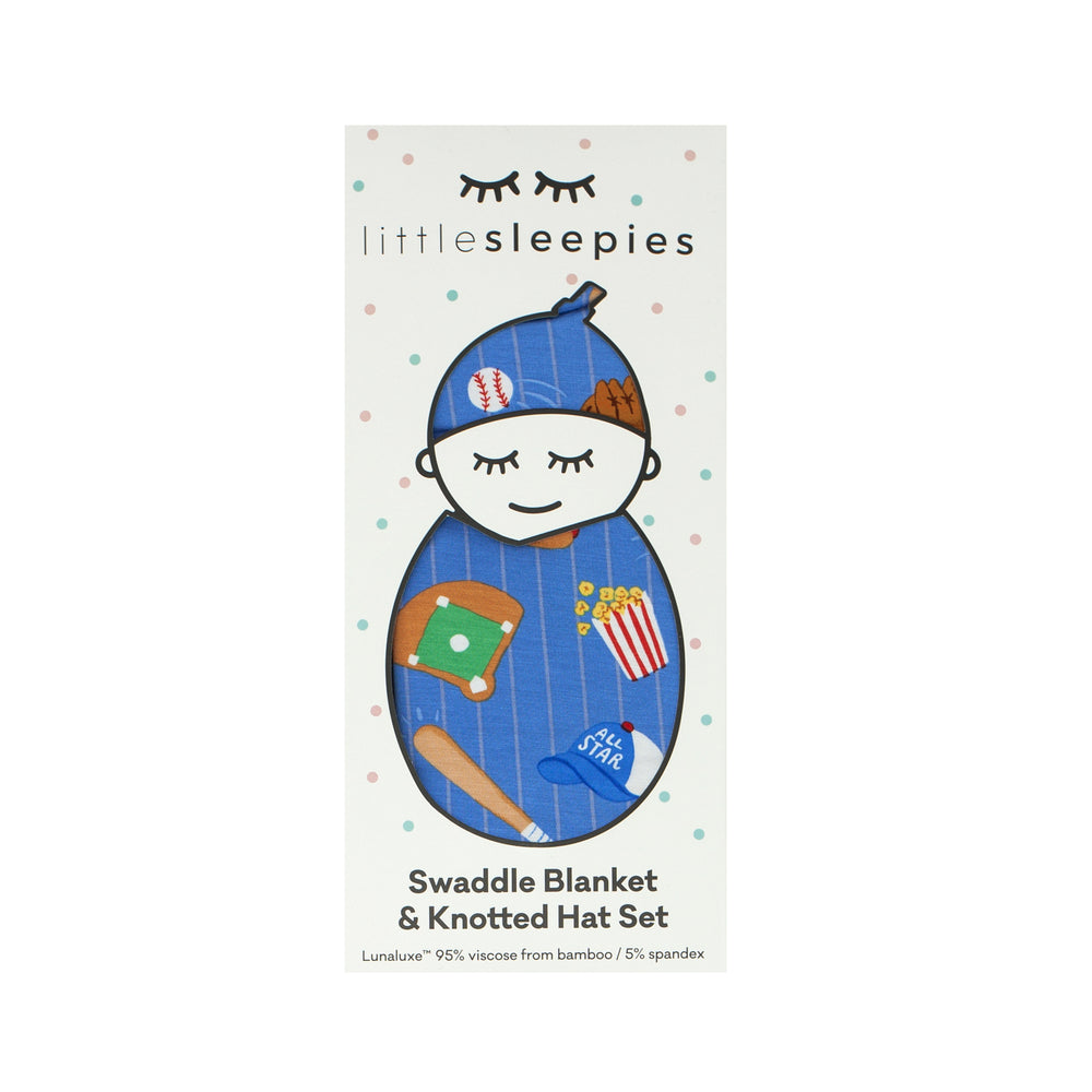 Flat lay image of a Blue All Stars swaddle and hat set in Little Sleepies peek a boo packaging