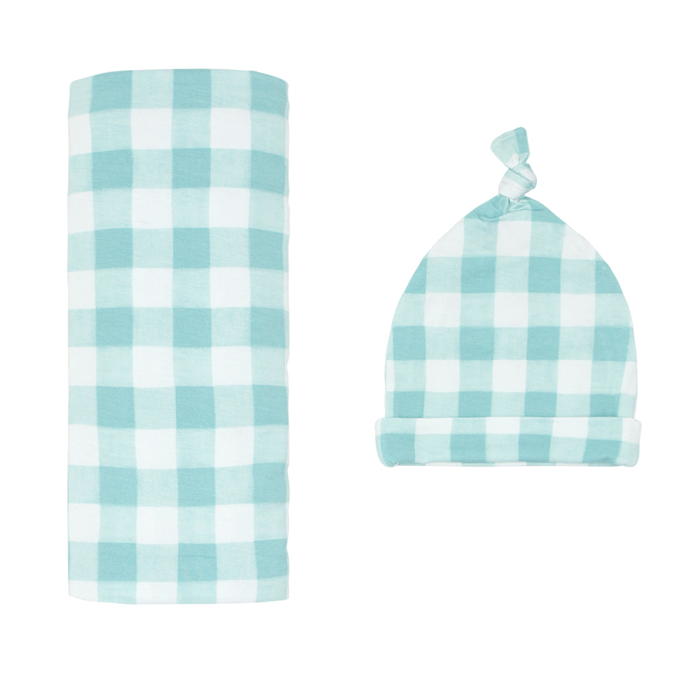 Click to see full screen - Flat lay image of a Aqua Gingham swaddle and hat set