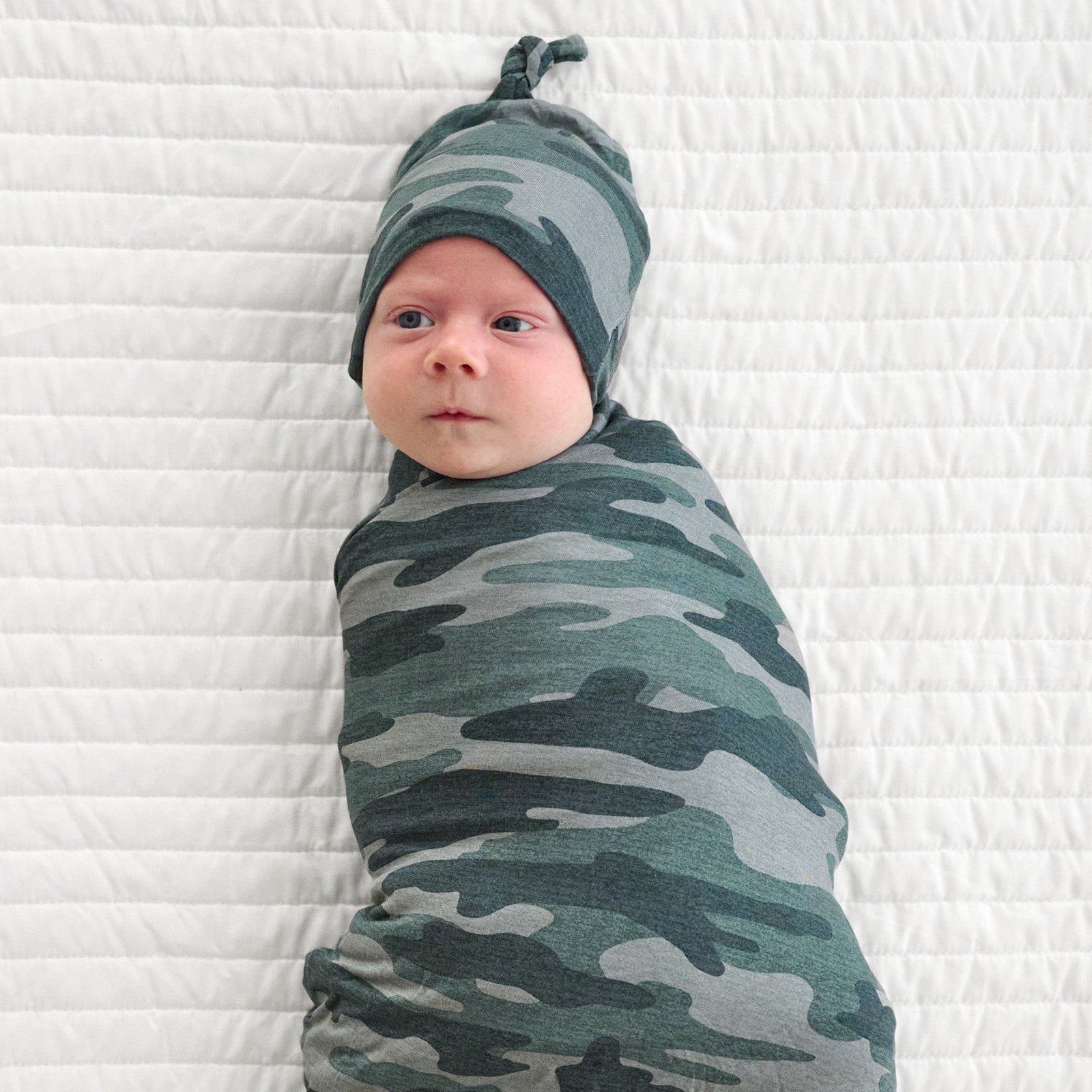 Alternative top view image of baby wearing the Vintage Camo Swaddle & Hat Set