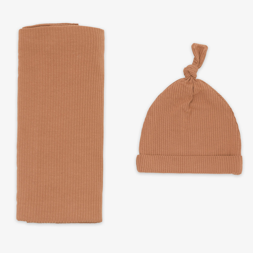 Flat lay image of the Caramel Ribbed Swaddle & Hat Set