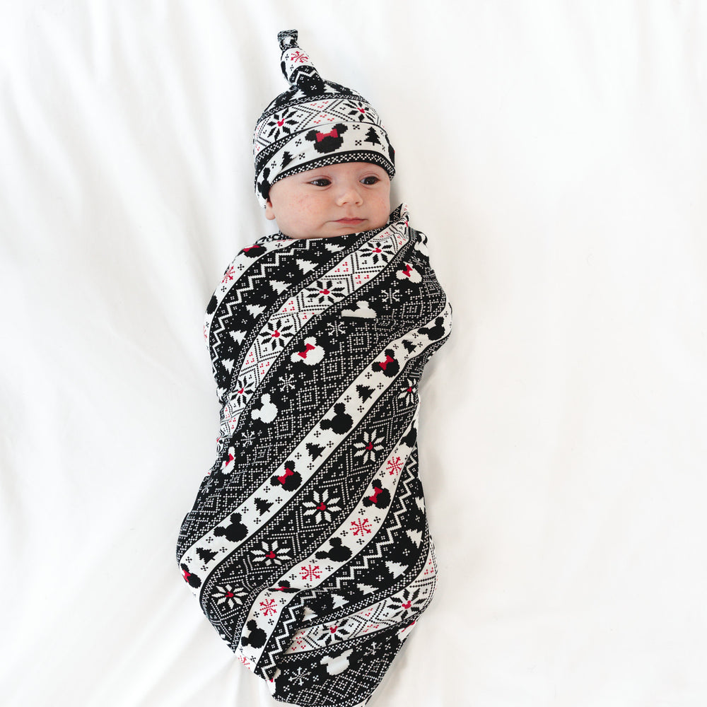 Child swaddled in a Mickey Fair Isle Swaddle and Hat set