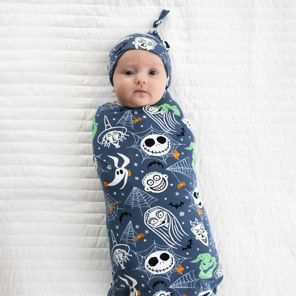 Top view image of baby laying down in the Disney Jack & Crew Swaddle & Hat Set