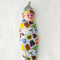 Infant swaddled in a Legends of the Galaxy swaddle & hat set
