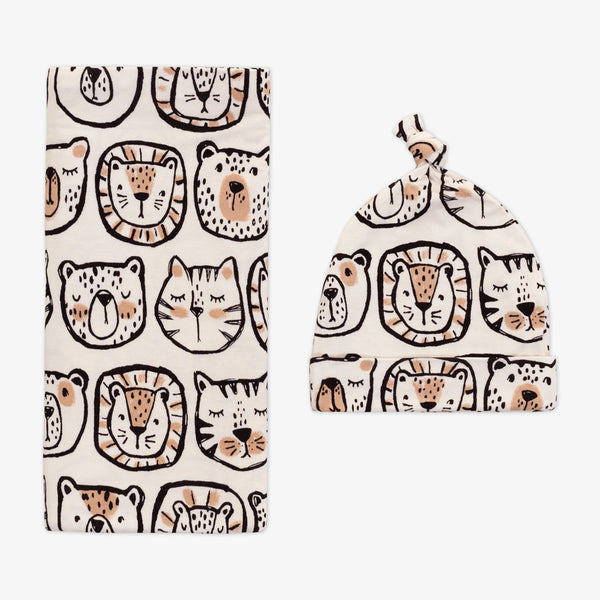 Flat lay image of a Lions, Tigers, and Bears swaddle and hat shit