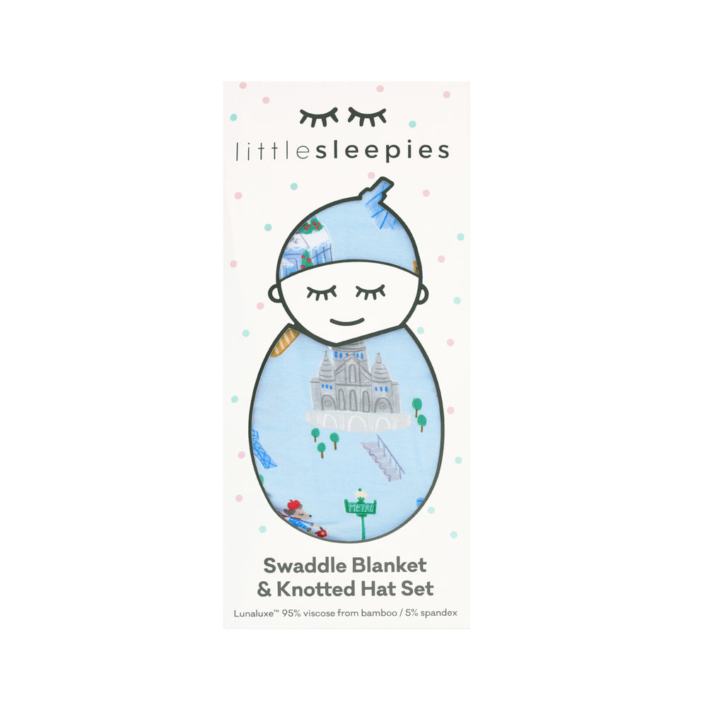 Image of the packaging for a Blue Weekend in Paris Swaddle & Hat Set