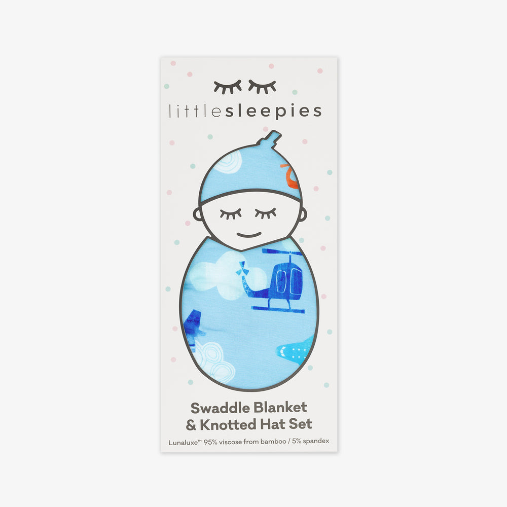 image of a  Let's Fly swaddle and hat set in Little Sleepies peek a boo packaging