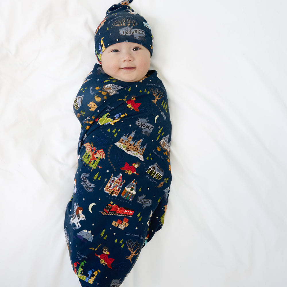 Image of a child swaddled in an Evening at Hogwarts swaddle and hat set