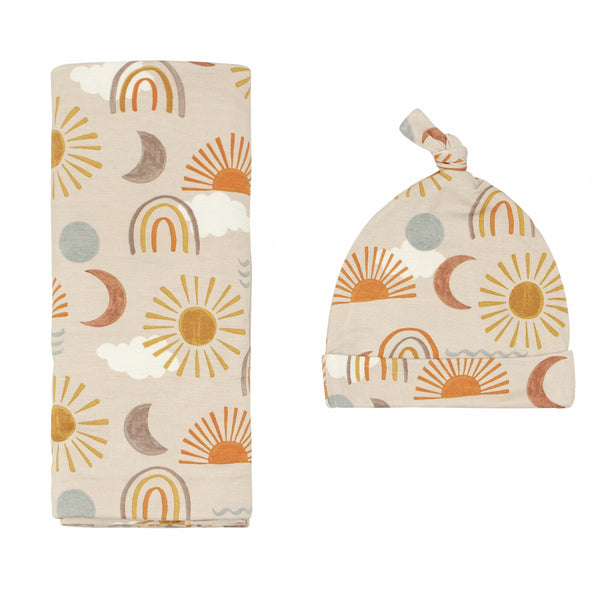 Flat lay image of a Desert Sunrise swaddle and hat set